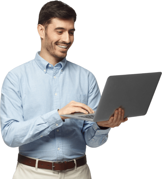 Happy Client Using Laptop After Website Launch by JaYo Designs Smiling man in blue shirt using a laptop, representing a satisfied JaYo Designs client after a successful website project
